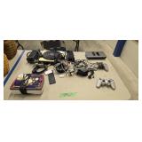 Video game controllers chords consoles as shown