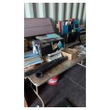 Folding table with office supplies, books, etc