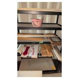 Metal shelf with lumber and signs