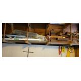 Lumber on shelf above workbench