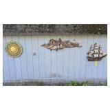 Wall art items on side of garage