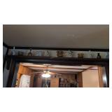 Figurines and bells over archway