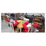 kitchen table with three chairs and Santa Claus