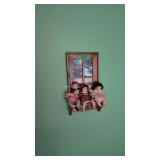 small shelf with doll babies