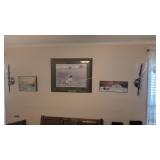 pewter candle holders and pictures on wall