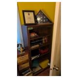 bookshelf with books and flag
