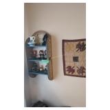 small wall shelf with figurines and miniature