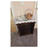 small lift top stand with items on top