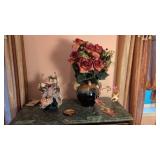 doll figure cherub figure and vase with flowers