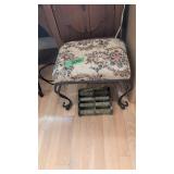 small embroidered footstool with metal base and