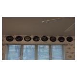 8 fish plates on wall