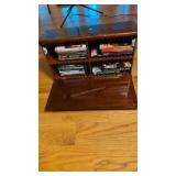 small box with DVDs under table