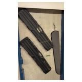 two hard plastic gun cases and one cloth hard