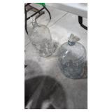 two glass 5 gallon water bottles