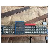 Hardware Organizer Bins Filled with Fasteners and Two Crosscut Saws