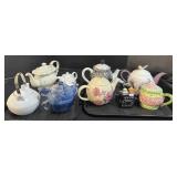 9 Teapots, 1 Teacup.