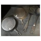 2 Cast Iron Pans, 2 Large Utensils.