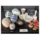 Painted Eggs, Bell, Glass Container, Bird Figures.