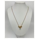 18KT Gold Diamond Bow Pendant on 14KT Chain.
