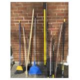 Large amount of brooms tools handles