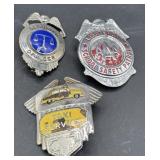 Three vintage security/taxi badges