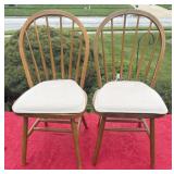 Two wooden padded chairs