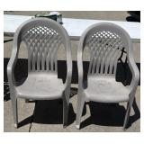 Two plastic lawn chairs