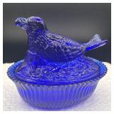 Cobolt blue bird on nest lid has crack/chip