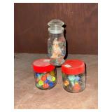 Marbles, quartz and colored glass in jars