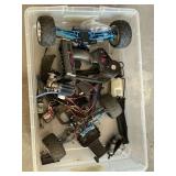 Parts of Traxxas 4-wheel drive RC car with engine, radio receiver