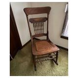 Woven bottom antique rocking chair