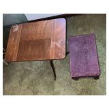 Small end table with water damage to top and upholstered foot stool