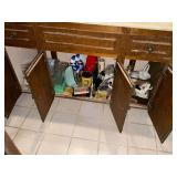 Contents of vanity, curling irons, cleaning supplies, curlers, soap dish