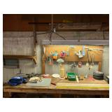 Contents of pegboard and top of work bench, apron, hatchet, wedges