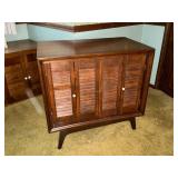 TV stand, swivel base, with 2 doors and shelves.