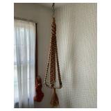 Macrame plant holder and wall hanger.