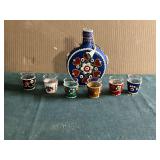 Leather covered flask and shot glasses.