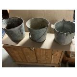 Pair of galvanized buckets and calf feeder bucket.