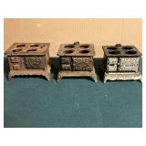 Pair of Queen cast iron mini stoves, and other, missing accessories.