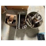 Pipe fittings in galvanized bucket, metal box of welding rods