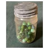 Jar with green and other marbles