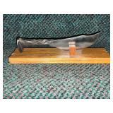 Knife handcrafted from a railroad spike on wooden stand