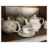 Teapots, cups and saucers
