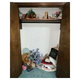Closet full of decorative items, candles, table linens,