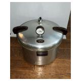 Presto pressure cooker with weight and racks inside