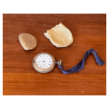 Elgin pocket watch with bent case, missing crystal, leather pouch