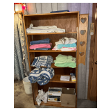 Shelf and contents including towels, comforter