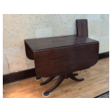 Duncan Phyfe dining table, slight water damage to the top, brass caps on feet