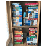 Assortment of puzzles, 2 bottom shelves