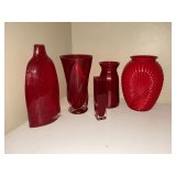 Five red glass vases